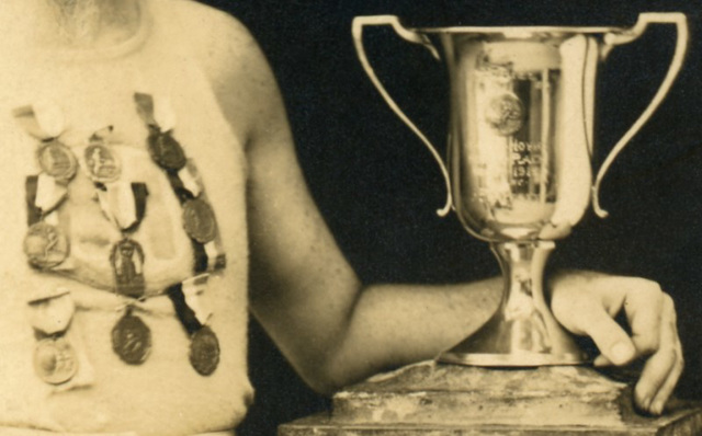 Athlete with Trophy and Medals (Cropped)