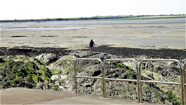 Girl exploring rock pools