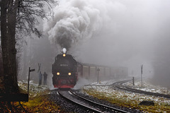 Locomotive 99-7232-4 emerges from fog,