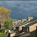 sunlit chimneys in a grey sky