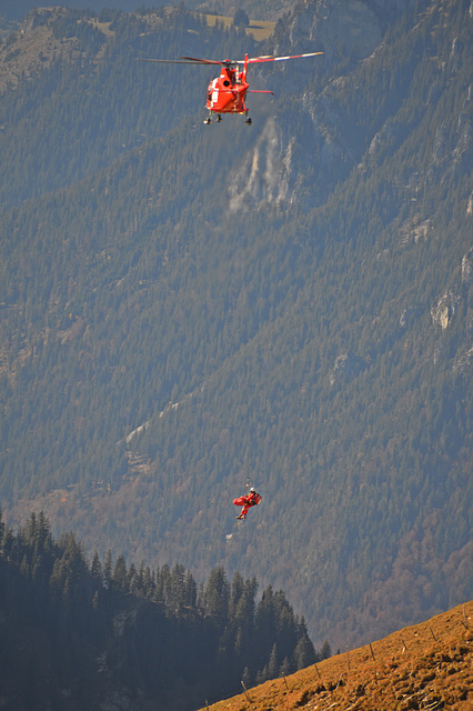 Notarzt und Patient am Seil zum Helikopter