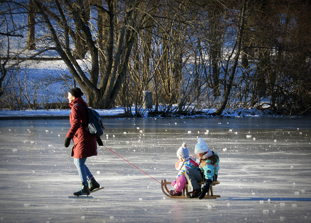 On skates and sitting on the sledge. Westpark Munich.