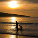 Water games at sunset of the beach Jimbaran, Bali