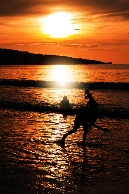 Water games at sunset of the beach Jimbaran, Bali