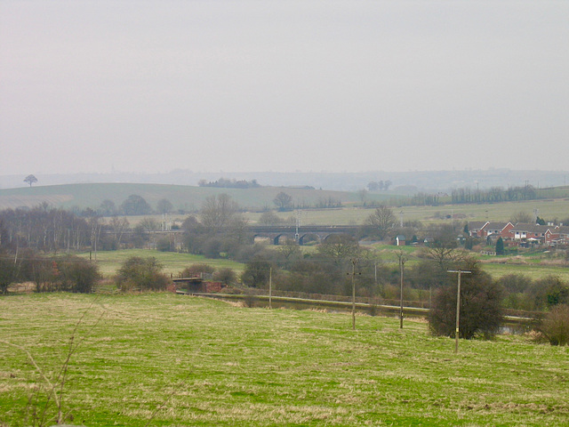 Looking over the Coventry Canal to the railway bridge over the River Anker from the Pooley Hall Colliery War Memorial.