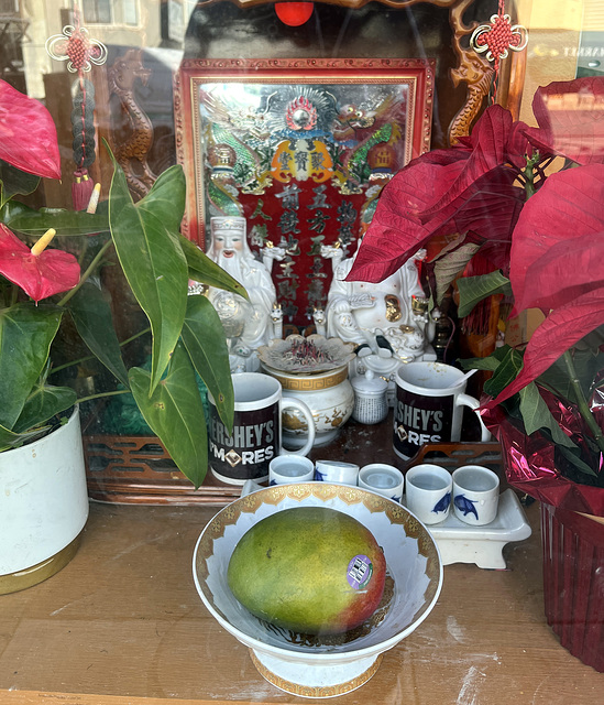 Shrine with Hershey mugs and mango