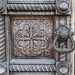 Detail of carved door and bronze knocker