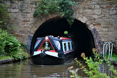 Canal boat leaves the tunnel at Tardebigge.