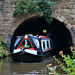 Canal boat leaves the tunnel at Tardebigge.