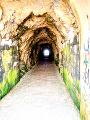 From this cliff's side the sea is serene, but at the tunnel top it's wild