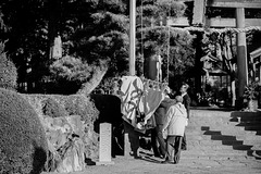 Hoisting the flag at a shrine