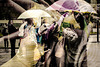 A Double Exposure Involving Bus Queues and Umbrellas