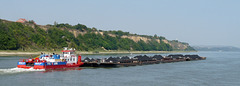 Coal Barges Passing Sandstone Cliffs