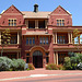 Goodman Building with flowering Agave americana