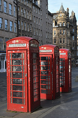 Three tired looking telephone boxes