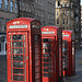 Three tired looking telephone boxes