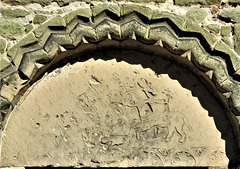 kedleston church derbs ; c12 doorway with huntsman on horseback blowing horn, a hound at his feet