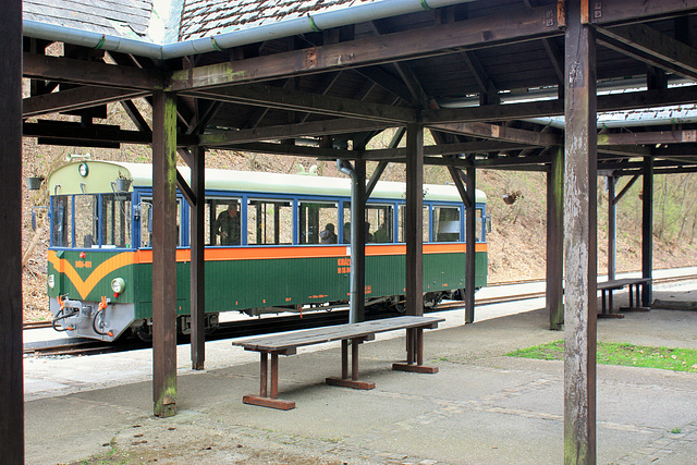 Train waiting next to a bench