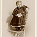 Girl Holding Photo and Standing on Chair