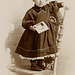 Girl Holding Photo and Standing on Chair (Cropped)