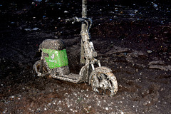 Electric scooter left to rot in the mud.