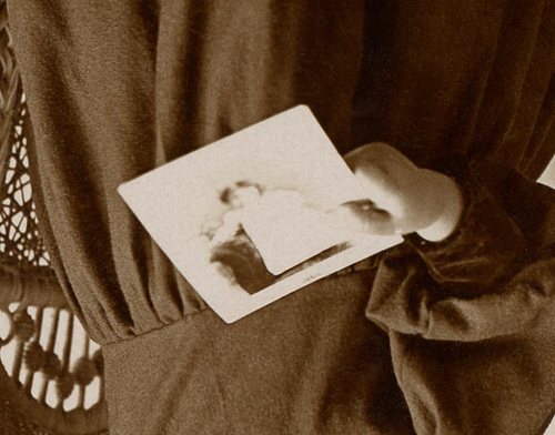 Girl Holding Photo and Standing on Chair (Detail)