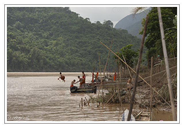 Bathing monks in the Mekong River in Ban Xang Hai