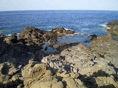 Rugged coast of volcanic rock.