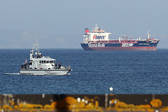 University Royal Naval Unit HMS Archer (P264) passes in front of oil tanker Stena Penguin