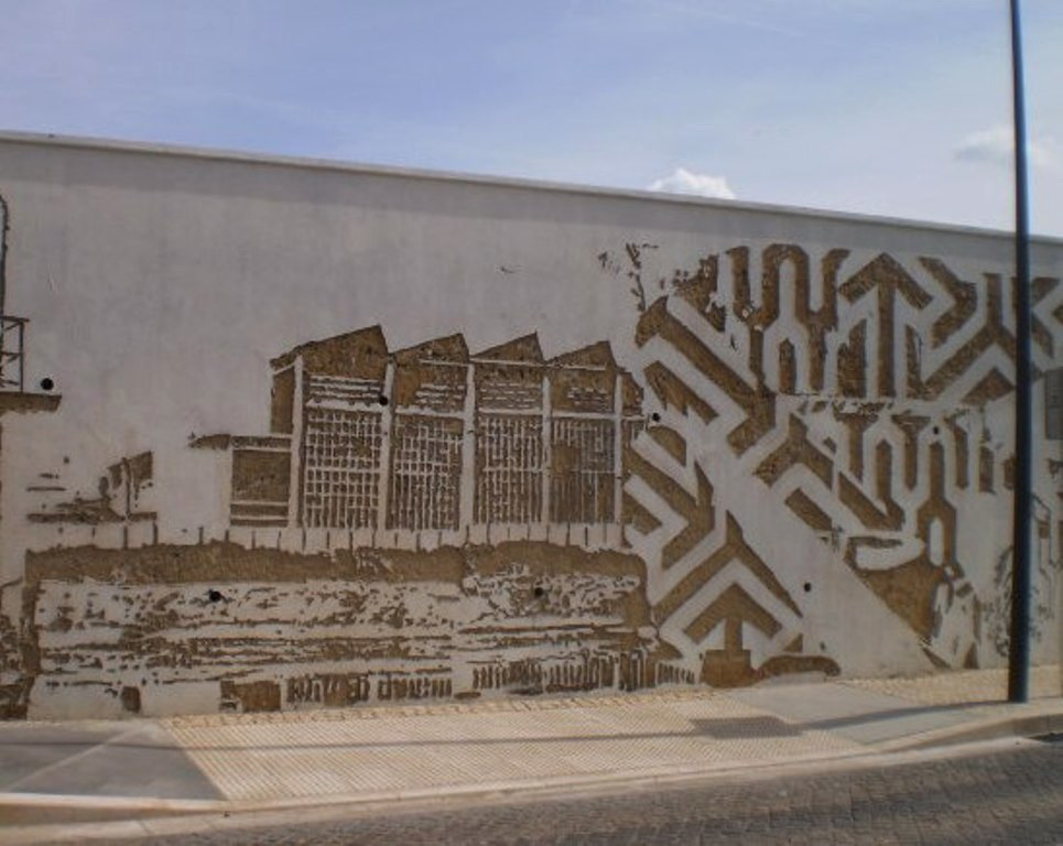 Industrial scenery in Vhils' mural.