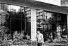 fence reflections on street bw