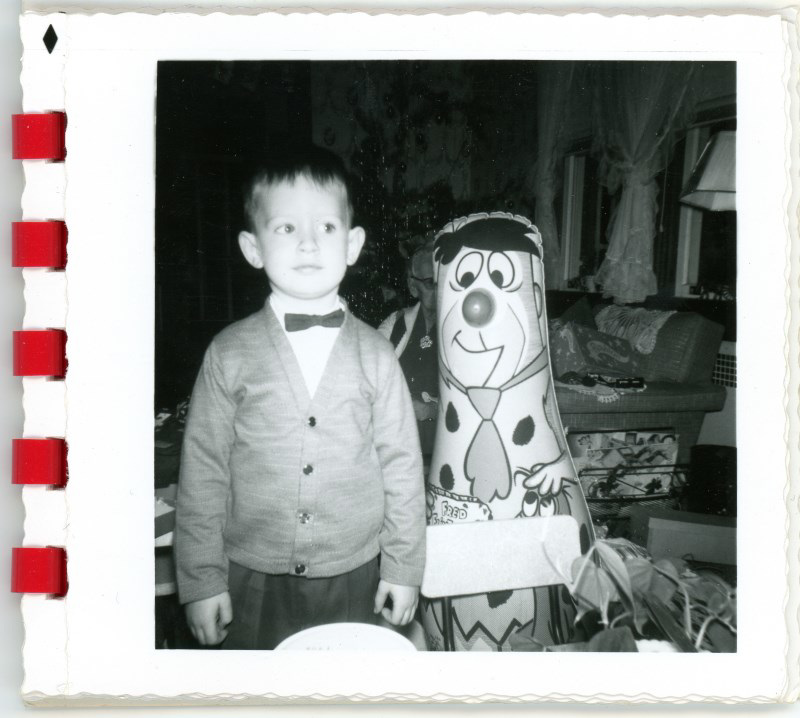 A Boy and His Fred Flintstone Punching Bag