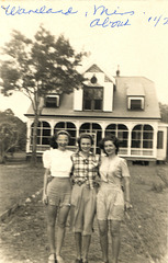 Three women stand before a DISTINCTIVE HOUSE in the Vintage Photos Theme Park