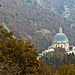 The dome of the New Church of Oropa emerges from the autumn colors.